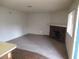 Cozy living room featuring plush carpeting and a rustic stone fireplace to unwind and relax at 1341 Cinder Rock Dr # 101, Las Vegas, NV 89128