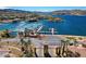Lakefront with marina, blue water, condos with tile roofs, and gate to the exclusive community at 15 Via Mantova # 308, Henderson, NV 89011