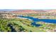 Panoramic aerial view of the community showcasing the lake, golf course, waterfront buildings, and desert landscape at 15 Via Mantova # 308, Henderson, NV 89011