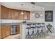 Chic bar area with sleek counter, wine fridge, ample storage, and stylish seating, perfect for entertaining guests at 15 Via Mantova # 308, Henderson, NV 89011