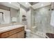 Bright bathroom with a glass shower, vanity and tile flooring at 15 Via Mantova # 308, Henderson, NV 89011
