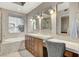 Bathroom with soaking tub, vanity, and large window to bring in natural light at 15 Via Mantova # 308, Henderson, NV 89011