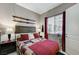 Bedroom featuring a window, skis mounted on the wall, and bedside lamps at 15 Via Mantova # 308, Henderson, NV 89011