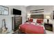 Comfortable bedroom featuring a stylish bed, TV, and unique wall decor at 15 Via Mantova # 308, Henderson, NV 89011