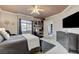 Bright bedroom with ceiling fan, large window, and workstation with a decorative ceiling at 15 Via Mantova # 308, Henderson, NV 89011