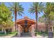 Exterior of club house entrance with stone pillars and mature landscaping at 15 Via Mantova # 308, Henderson, NV 89011