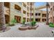 Picturesque courtyard with lush landscaping, paver stones, balconies, and stucco exterior at 15 Via Mantova # 308, Henderson, NV 89011