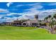 Clubhouse exterior featuring lush green lawn and mountain views at 15 Via Mantova # 308, Henderson, NV 89011