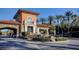 Elegant gated community entrance with stone features, fountain, and lush landscaping at 15 Via Mantova # 308, Henderson, NV 89011