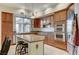 Well-equipped kitchen featuring granite counters, stainless steel appliances, and plentiful wooden cabinets for ample storage at 15 Via Mantova # 308, Henderson, NV 89011