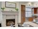 Cozy living space featuring a fireplace, dining area, and adjacent kitchen space with ample cabinetry and natural light at 15 Via Mantova # 308, Henderson, NV 89011