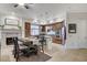 Inviting dining and kitchen area with a fireplace, modern appliances, and stylish decor at 15 Via Mantova # 308, Henderson, NV 89011