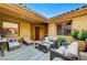 Charming outdoor patio featuring cozy seating, potted plants, and a welcoming ambiance at 15 Via Mantova # 308, Henderson, NV 89011