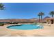Inviting swimming pool with scenic views of mountains, lush landscaping, and comfortable seating areas at 15 Via Mantova # 308, Henderson, NV 89011