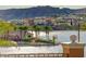 View of the lake from condo with island, mature trees, and other condos in the community at 15 Via Mantova # 308, Henderson, NV 89011