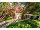 A serene backyard with lush greenery, offers an inviting lawn, patio area, and cozy outdoor seating for relaxation and entertainment at 1601 Becke Cir, Las Vegas, NV 89104