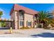 Two-story home featuring a red tile roof and lush landscaping, complemented by black metal window accents at 1601 Becke Cir, Las Vegas, NV 89104