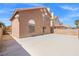 Large backyard featuring desert landscaping, concrete patio, and two-story house at 1892 Falcon Ridge St, Las Vegas, NV 89142