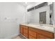 Bathroom boasts double sinks with wooden cabinets, a large mirror, and modern fixtures at 1892 Falcon Ridge St, Las Vegas, NV 89142