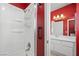 Cozy bathroom featuring a shower and single sink vanity with red accent wall at 1892 Falcon Ridge St, Las Vegas, NV 89142