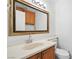 Bathroom features a sink with wooden cabinets, a large mirror, and modern fixtures at 1892 Falcon Ridge St, Las Vegas, NV 89142