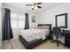 Comfortable bedroom with a queen bed, desk, and a ceiling fan at 1892 Falcon Ridge St, Las Vegas, NV 89142