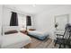 Cozy bedroom with two twin beds, light walls, and wood-look flooring at 1892 Falcon Ridge St, Las Vegas, NV 89142