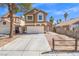 Charming two-story home with a well-manicured lawn and attached two-car garage on a sunny day at 1892 Falcon Ridge St, Las Vegas, NV 89142
