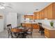 Charming kitchen features wood cabinets, white countertops, and an adjacent dining area for cozy meals at 1892 Falcon Ridge St, Las Vegas, NV 89142