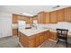 Bright kitchen with wood cabinets, white countertops, and stainless steel appliances offers a functional cooking space at 1892 Falcon Ridge St, Las Vegas, NV 89142
