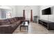 Comfortable living room with hardwood floors, a cozy couch, and a large window for ample natural light at 1892 Falcon Ridge St, Las Vegas, NV 89142