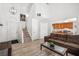 Bright open-concept featuring a cozy sofa and direct access to both the kitchen and the staircase at 1892 Falcon Ridge St, Las Vegas, NV 89142