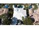 Expansive property featuring a modern white roof, lush greenery, and a sparkling backyard pool at 2339 Prometheus Ct, Henderson, NV 89074