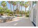 Lush backyard featuring a pool, jacuzzi, and outdoor seating area surrounded by beautiful landscaping and palm trees at 2339 Prometheus Ct, Henderson, NV 89074