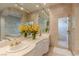 Modern bathroom featuring double sinks, white cabinets and a glass-door shower at 2339 Prometheus Ct, Henderson, NV 89074