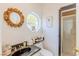 Bathroom featuring decorative mirror, unique octagon window, and glass door shower at 2339 Prometheus Ct, Henderson, NV 89074