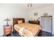 Cozy bedroom featuring natural light, dark floors, and soft yellow bedding at 2339 Prometheus Ct, Henderson, NV 89074