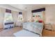 Bright bedroom with a large window, writing desk, a king bed and decorative carpet at 2339 Prometheus Ct, Henderson, NV 89074