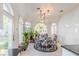 Bright dining area with arched windows, elegant chairs, and modern lighting fixtures at 2339 Prometheus Ct, Henderson, NV 89074