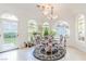 Bright dining area with multiple arched windows providing ample natural light and garden views at 2339 Prometheus Ct, Henderson, NV 89074
