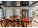 Dining room showcasing a long wooden table, ornate china cabinet, and view of the staircase at 2339 Prometheus Ct, Henderson, NV 89074