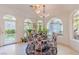 Eat-in dining area boasting lots of light, round glass table, and bright upholstered chairs at 2339 Prometheus Ct, Henderson, NV 89074