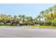 Community entrance with lush landscaping, mature palms, and a security gate at 2339 Prometheus Ct, Henderson, NV 89074