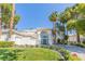 Grand home featuring a manicured lawn, circular driveway, and striking architectural details at 2339 Prometheus Ct, Henderson, NV 89074