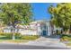 Stately home with manicured lawn, mature trees, and a circular driveway entrance at 2339 Prometheus Ct, Henderson, NV 89074
