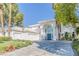 Impressive home boasting lush landscaping, palm trees, and a circular driveway entrance at 2339 Prometheus Ct, Henderson, NV 89074