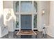 Close-up view of the home's grand double doors with a decorative rug and charming dog statue at 2339 Prometheus Ct, Henderson, NV 89074