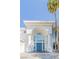 Elegant home entrance featuring a grand archway, stately columns, and striking blue double doors at 2339 Prometheus Ct, Henderson, NV 89074