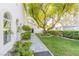 Beautiful front yard with lush landscaping, stone pathway, and mature trees at 2339 Prometheus Ct, Henderson, NV 89074
