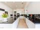 Spacious kitchen featuring sleek white cabinetry and black countertops, filled with natural light at 2339 Prometheus Ct, Henderson, NV 89074